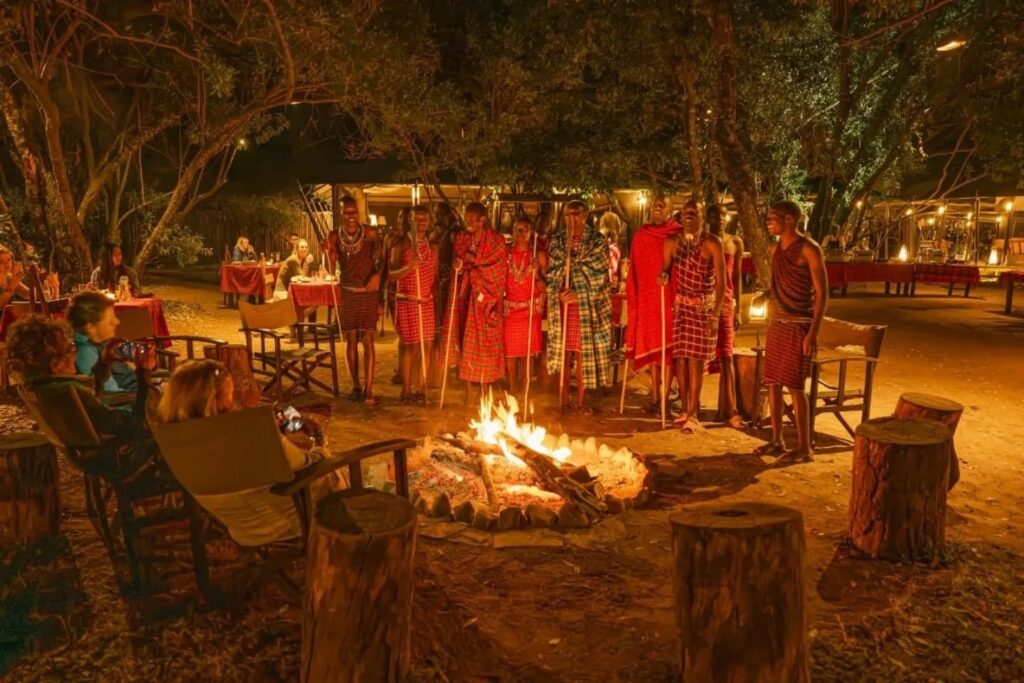 Maasai dancers entertaining guest in the camp fire area at Mara Bush Camp