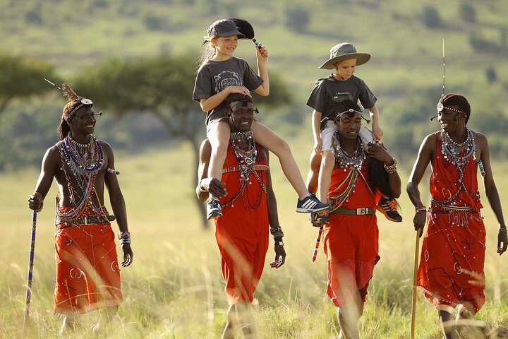 children with African safari guides
