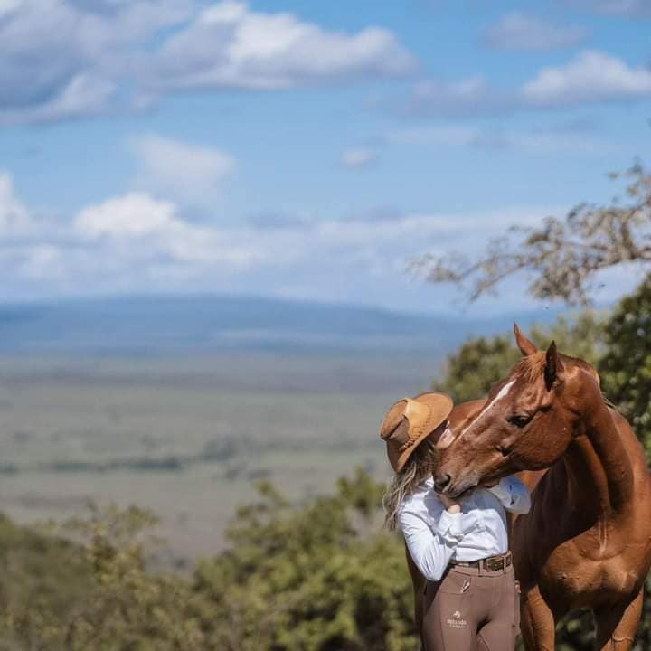 riding a horse in a safari