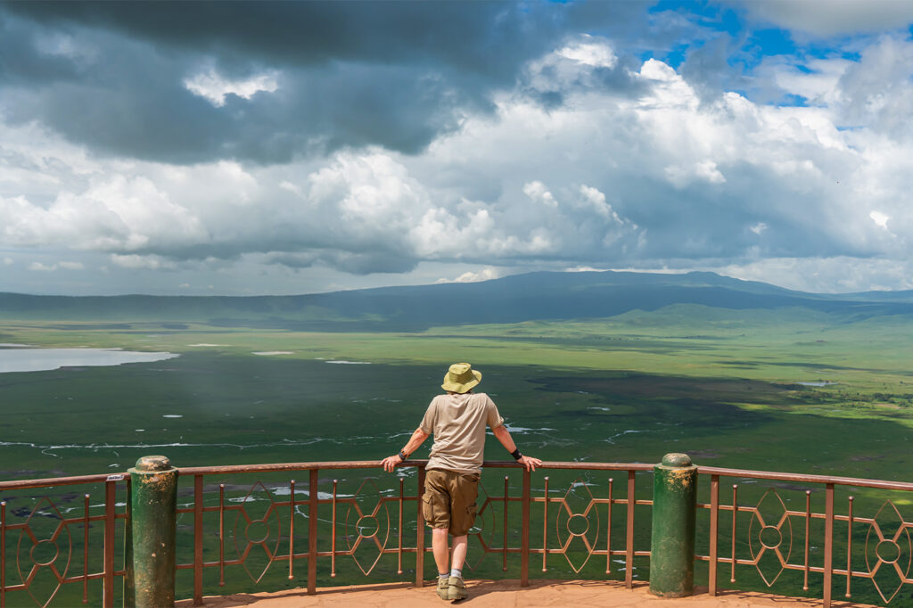 a tourist gazing at Ngorongoro Crater in tanzania