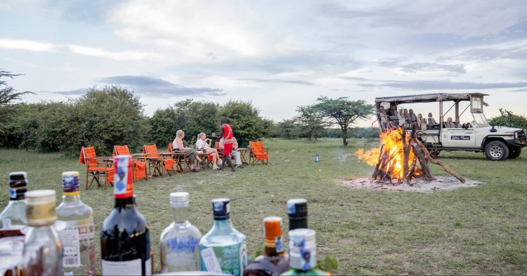 tourists enjoying an evening treat after a game drive at Zebra Plains Mara Camp